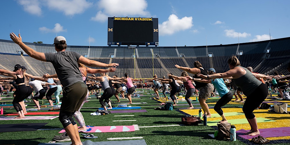 Experience wellness and charity through yoga in the iconic Michigan Stadium.